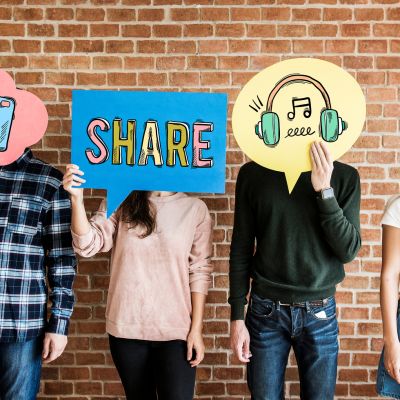 Friends holding up thought bubbles with social media concept ico