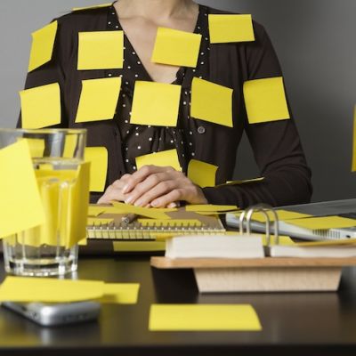 Businesswoman Covered in Sticky Notes